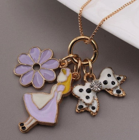 Dancing Doll Multiple Charm Pendant with a Flower and a Pretty Bow in Purple color